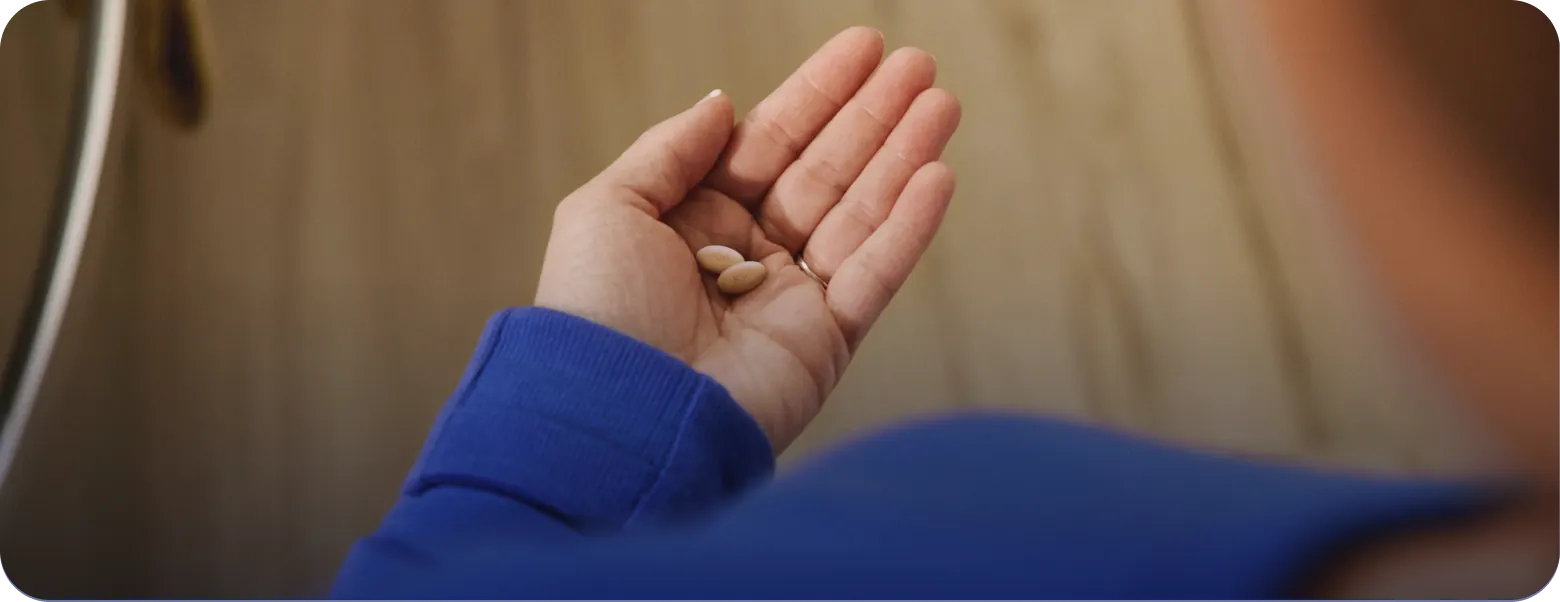 Hand holding EKTERLY® (sebetralstat) tablets