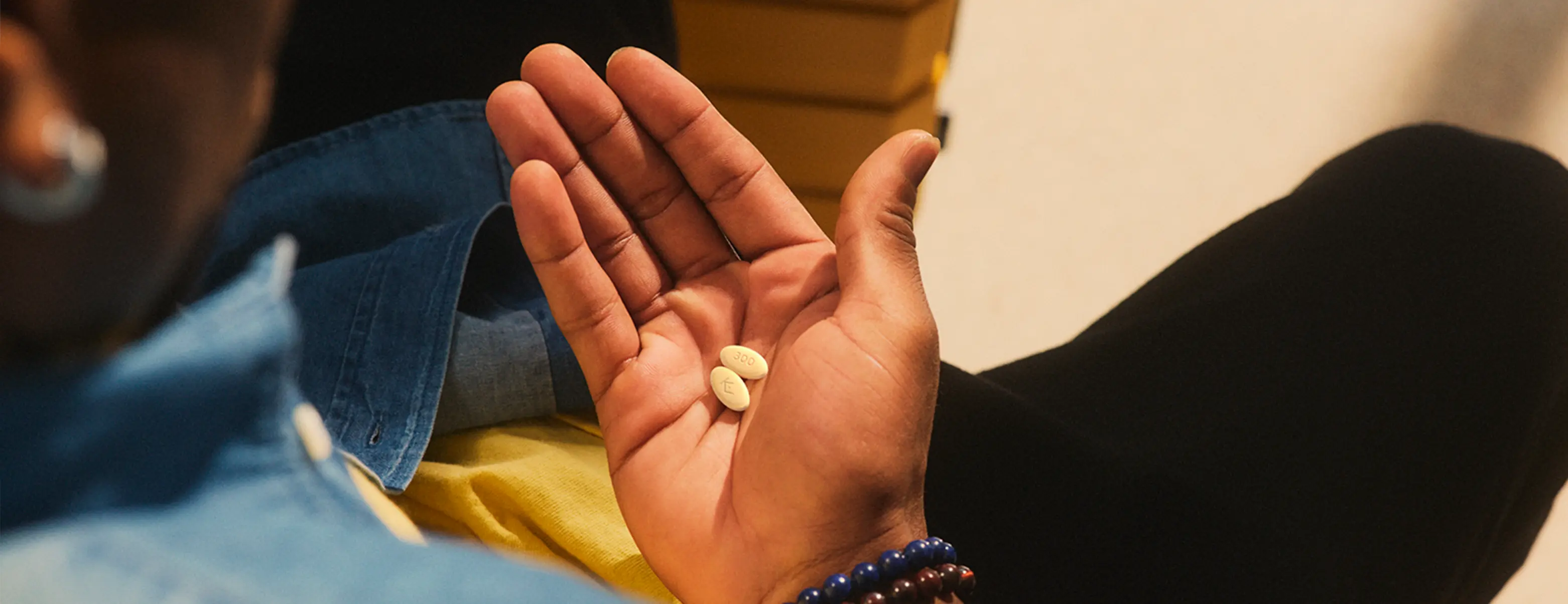 Hypothetical patient holding an EKTERLY® (sebetralstat) tablet