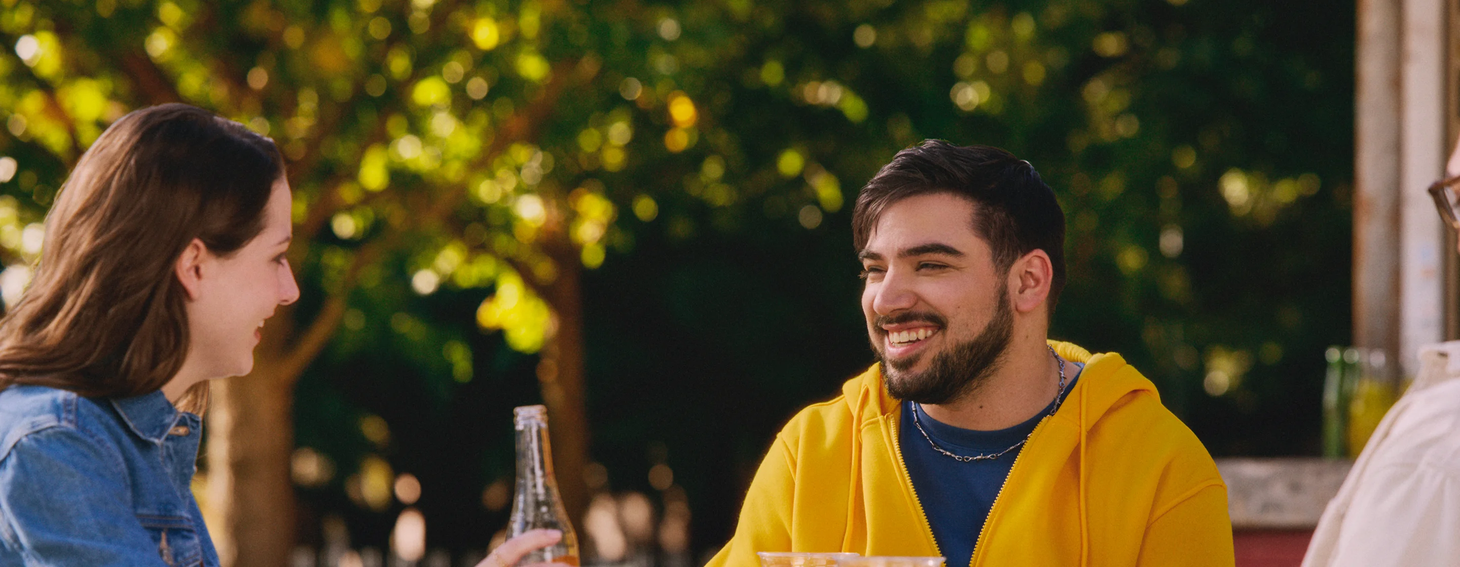 Real EKTERLY® (sebetralstat) patient Zach happily conversing with a friend