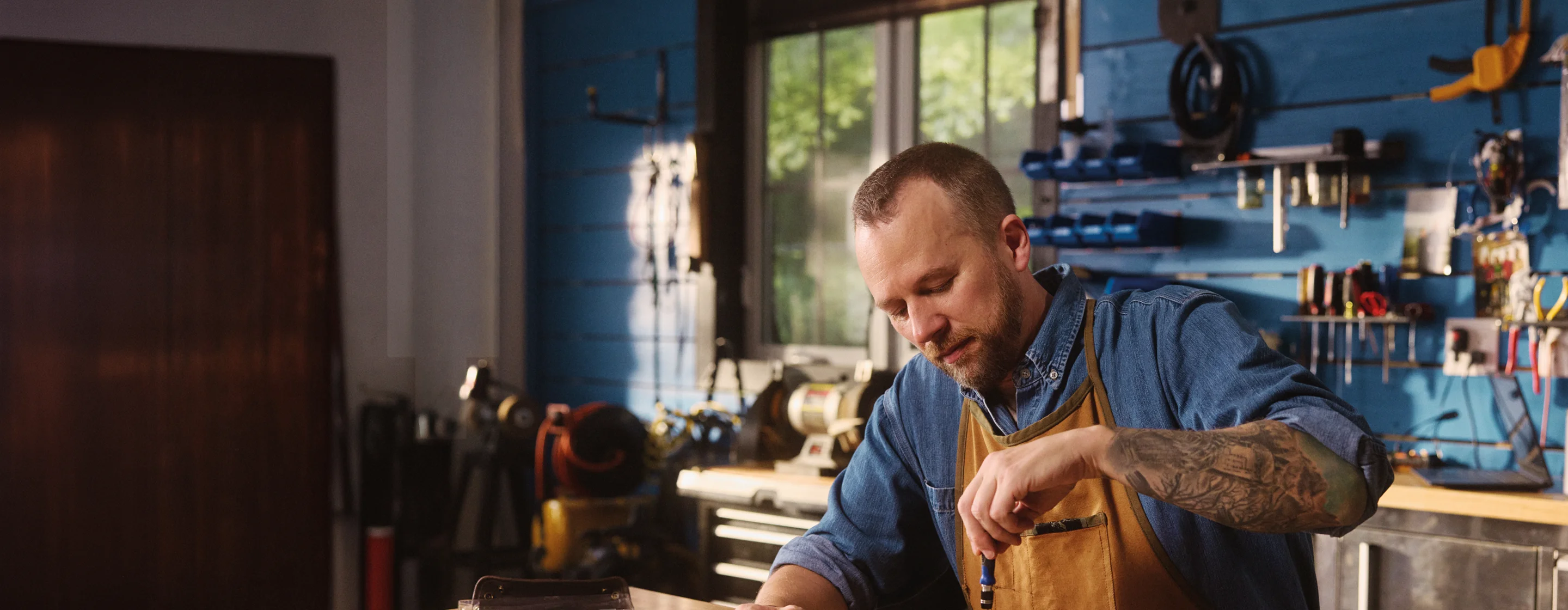 Real EKTERLY® (sebetralstat) patient Jason peacefully tightening a tool in his workshop