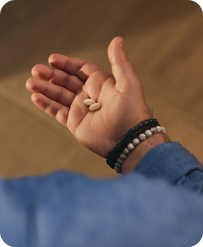 Hand holding EKTERLY® (sebetralstat) tablets