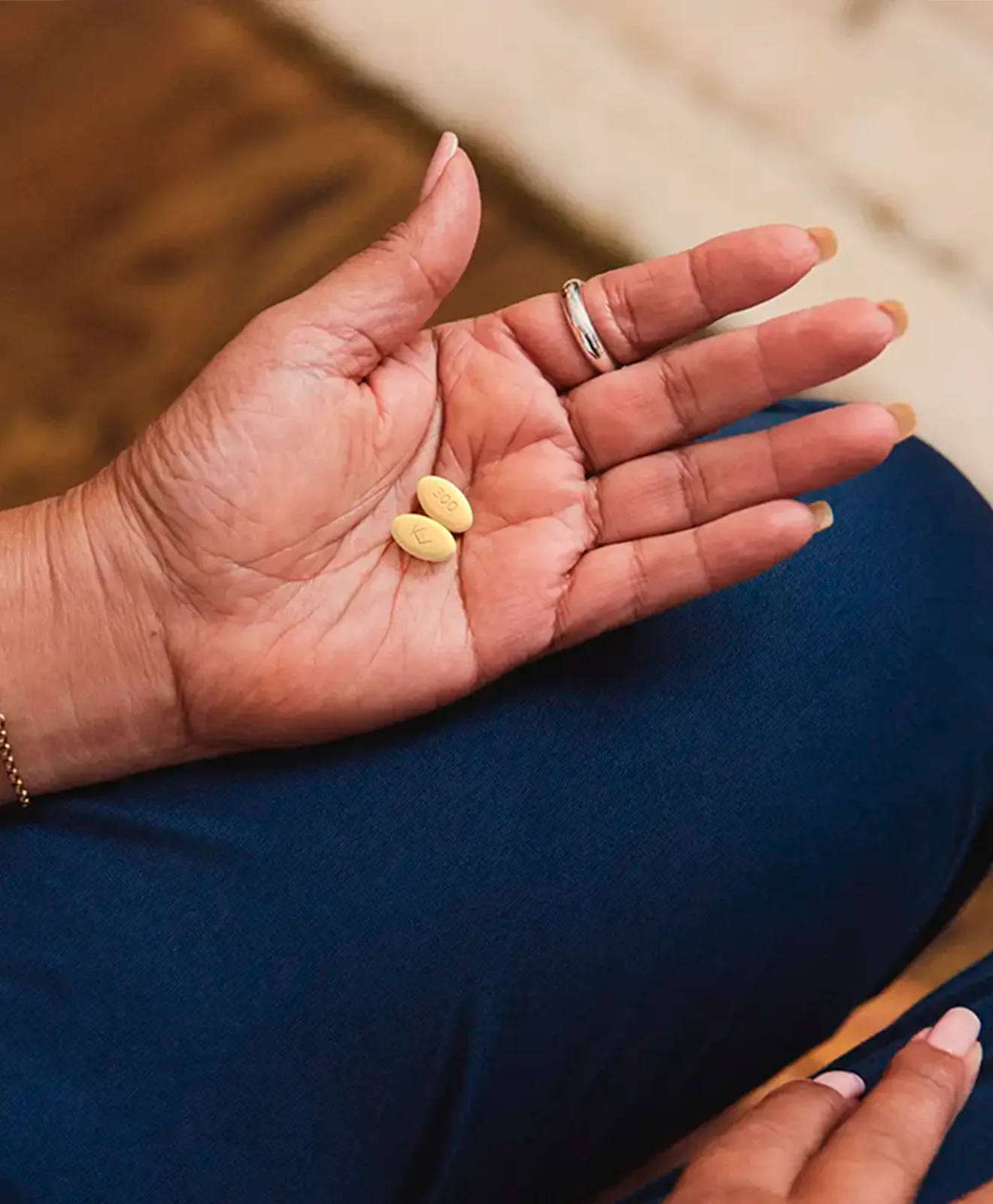 Hypothetical patient holding an EKTERLY® (sebetralstat) tablet
